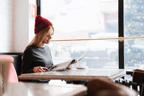 Side view of Beauty woman in cafe with journal