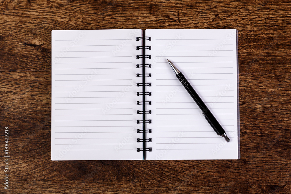 Notepad with pen on the wooden rustic desk. Mockup concept with empty notebook page. Mock-up of blank diary. Wooden rustic desk. Notepad with pen on the wooden rustic desk. Mockup concept with empty notebook page. Mock-up of blank diary. Wooden rustic desk.