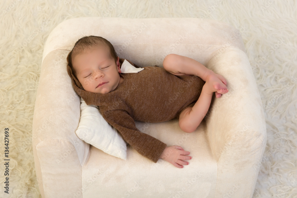 Newborn baby relaxing in armchair Newborn baby relaxing in armchair