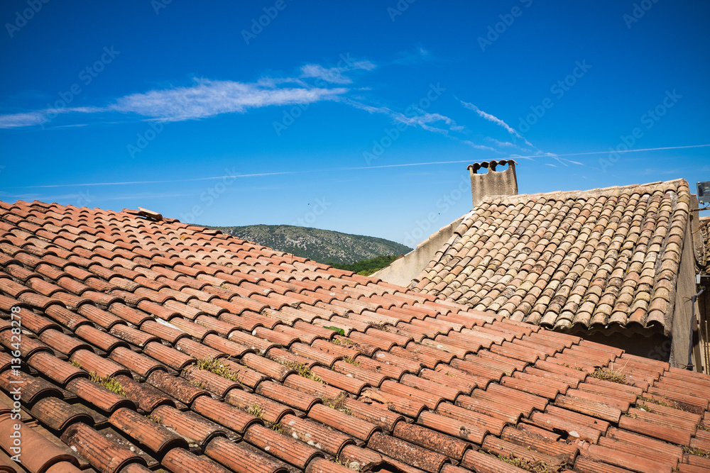 Fototapeta premium Mediterranean roofs with red tiles and blue sky in France