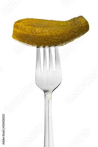 Fork with pickled cucumber closeup on white background