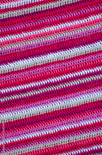Crochet fabric in white and red colors with a stripes pattern