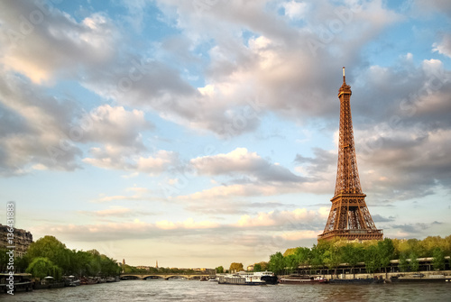 The Eiffel Tower and the river Seine at sunset sky background in Paris