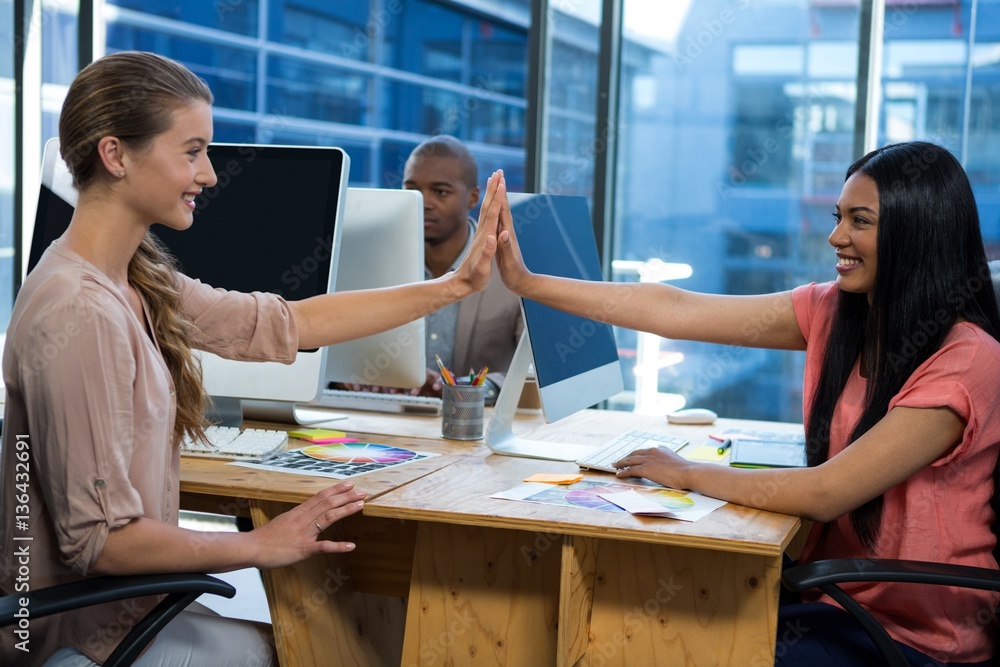 Business executives giving high five each other Business executives giving high five each other