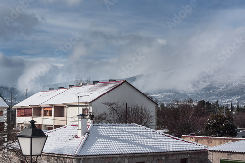 Snowy house in winter time. Subject captured after snow storm over blue sky background © Rosa
