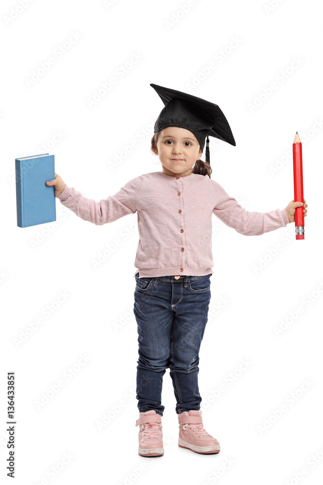 Little girl with mortarboard holding book and pencil