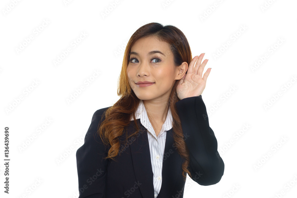 Young asian woman hand to ear trying to secretly listen in on a Young asian woman hand to ear trying to secretly listen in on a