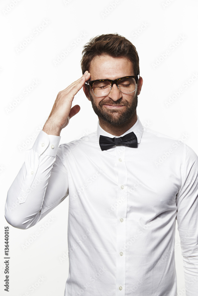 Guy in bow tie and shirt thinking hard Guy in bow tie and shirt thinking hard