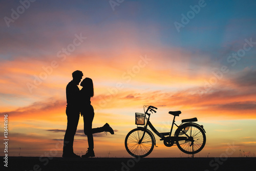 Silhouette of couple in love kissing in sunset. Couple in love.