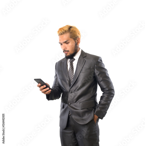 Business confident young man in suit using smartphone. Isolated © Johnstocker