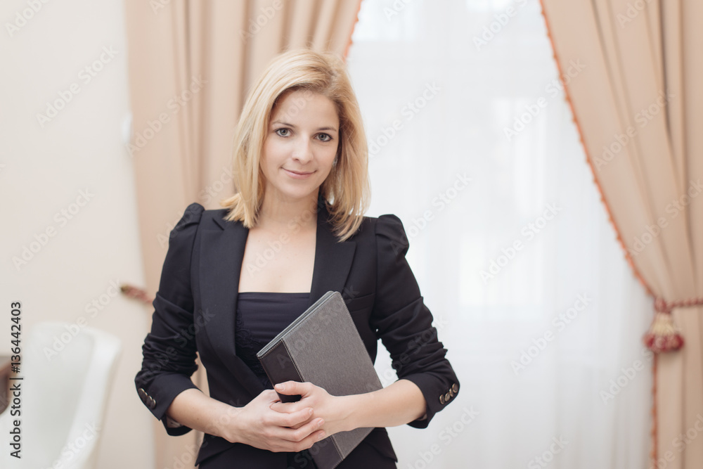 Businesswoman standing in hotel room with notes Businesswoman standing in hotel room with notes