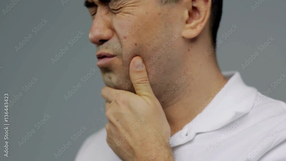 unhappy man suffering from toothache unhappy man suffering from toothache