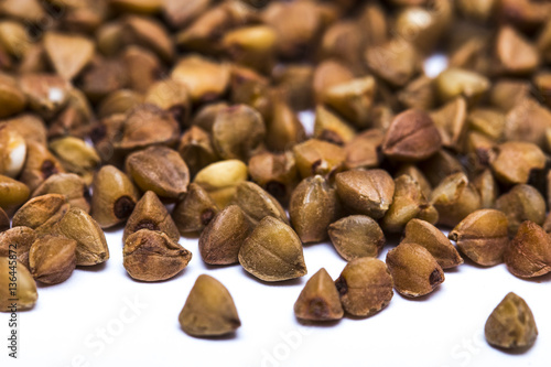 Pile of buckwheat seeds isolated over the white background