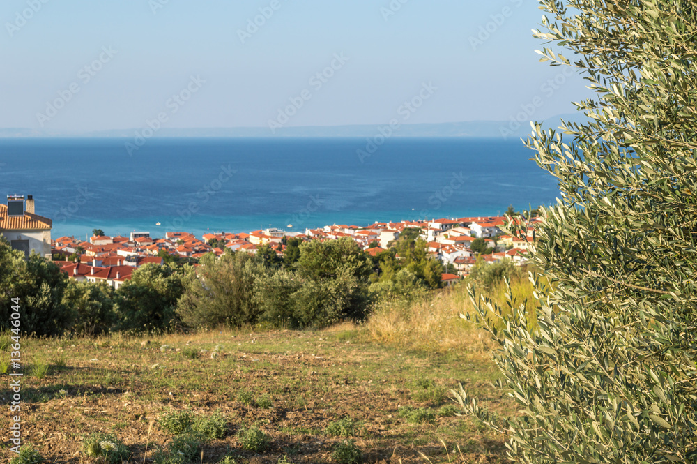 Scenic view from the hill at the white houses and blue sea. Halkidiki, Greece