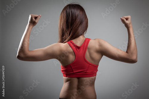 Back of Asian strong healthy girl with muscular body