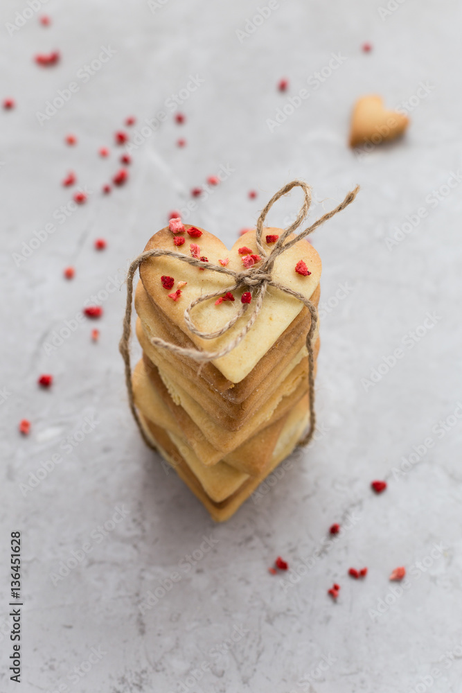 Top View of Stack of Homemade Heart Shaped Cookies Tied Together with Brown String Top View of Stack of Homemade Heart Shaped Cookies Tied Together with Brown String