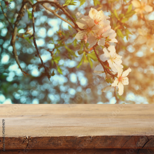 wooden table in front of cherry tree © tomertu