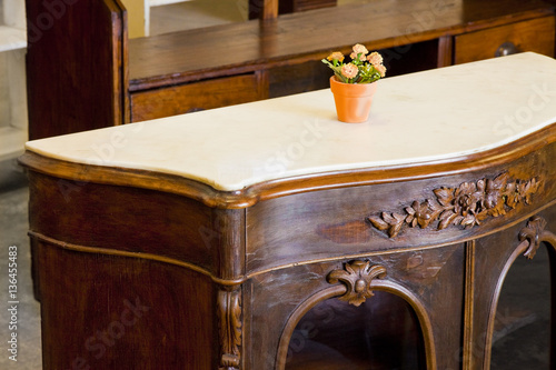 Fotografie Detail of an antique wooden italian furniture just restored