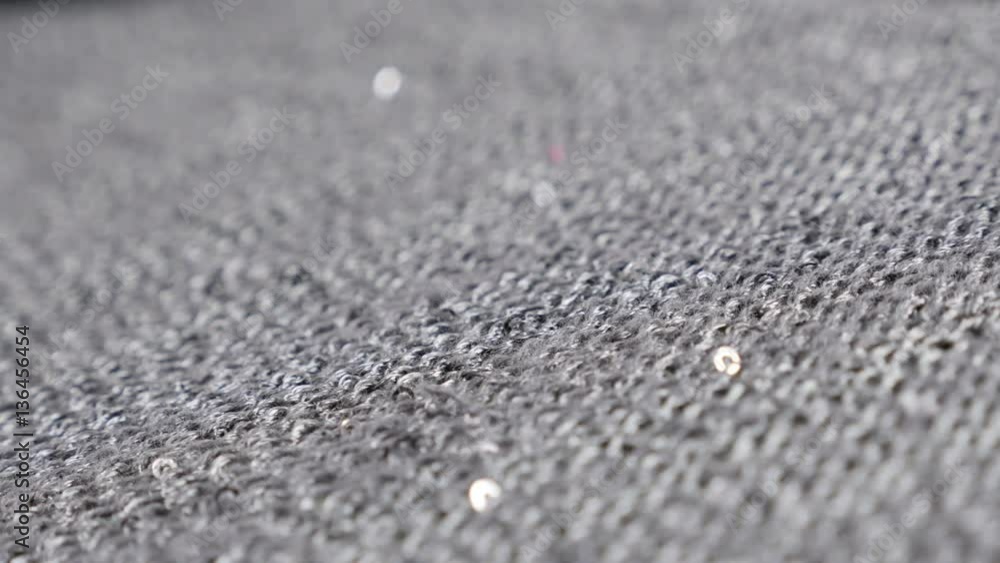 Women cardigan knitted surface with sequins close-up 4K 2160p 30fps UltraHD panning footage - Slow pan over shiny grey dress fine quality knitwork 3840X2160 UHD video Women cardigan knitted surface with sequins close-up 4K 2160p 30fps UltraHD panning footage - Slow pan over shiny grey dress fine quality knitwork 3840X2160 UHD video