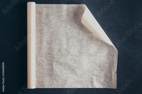 Baking paper on a dark background. Top view