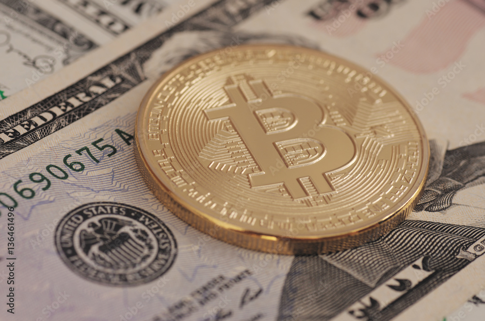 Golden plated Bitcoin on US dollar bills. Golden plated Bitcoin on US dollar bills.