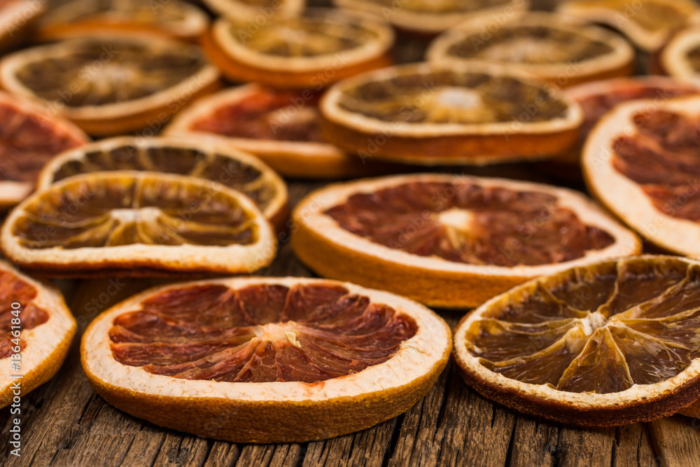 Fototapeta premium Dried oranges and grapefruits on an old wooden table.