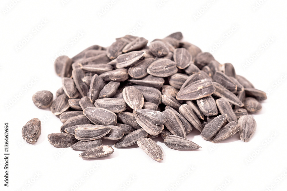 Bunch of sunflower seeds isolated on white Bunch of sunflower seeds isolated on white