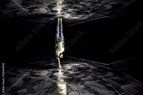 Conceptual photo of young and attractive man upside down between photo