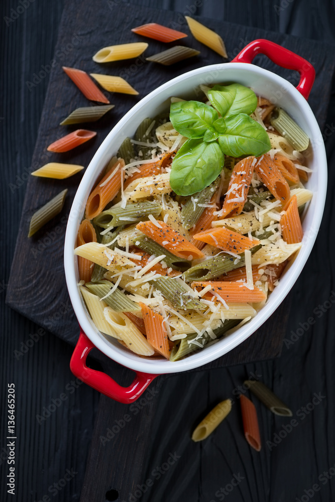 Italian penne tricolore with cheese topping in a casserole Stock Photo |  Adobe Stock