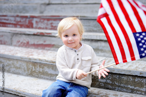 Cute toddler boy holding american flag © Maria Sbytova