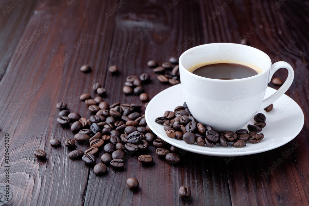 Coffee cup and coffee beans on wooden background Coffee cup and coffee beans on wooden background