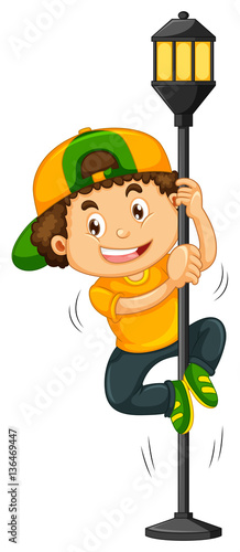 Boy climbing up the lamp post