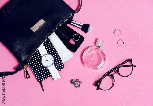 Top view of set female accessories on pink flat lay