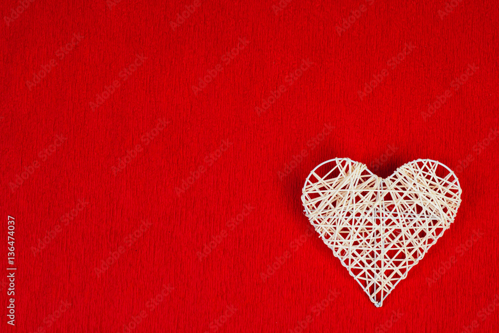 Woven heart on a red corrugated paper. Woven heart on a red corrugated paper.