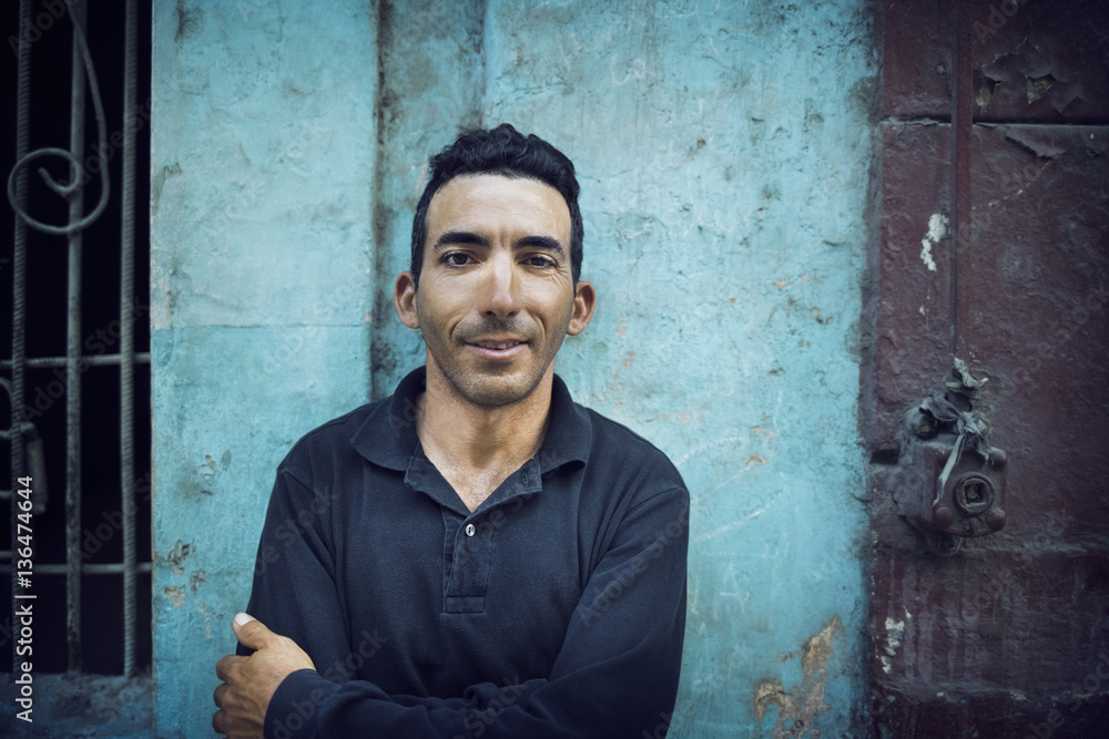 Portrait of man with arms crossed standing against wall Portrait of man with arms crossed standing against wall