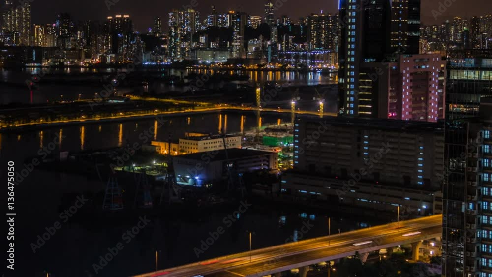 Timelapse Top View Hong Kong Cityscape Night, skyline of the city near Kowloon Bay with ships and cars in freeway front the Harbour -Dan Timelapse Top View Hong Kong Cityscape Night, skyline of the city near Kowloon Bay with ships and cars in freeway front the Harbour -Dan
