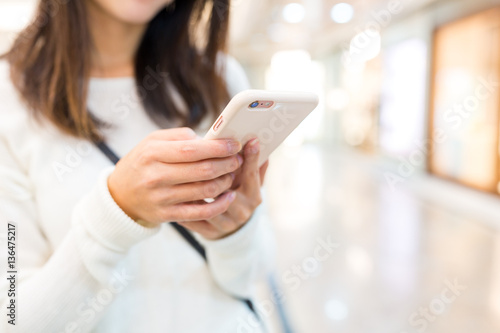 Woman sending text message on mobile phone