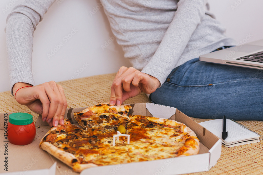Woman hand scoop up and slice of hot pizza with melting cheese Woman hand scoop up and slice of hot pizza with melting cheese