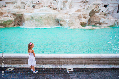 Adorable little girl near the Fountain of Trevi in Rome. Happy kid enjoy their european vacation in Italy © travnikovstudio