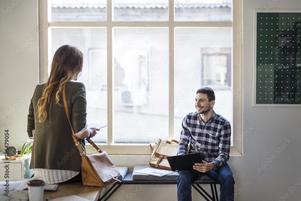 Man looking at friend while sitting in classroom Man looking at friend while sitting in classroom