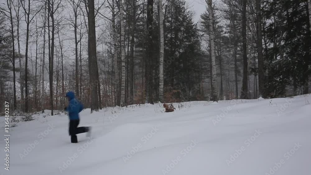 Man running through a winter landscape in a snow storm. Man running through a winter landscape in a snow storm.