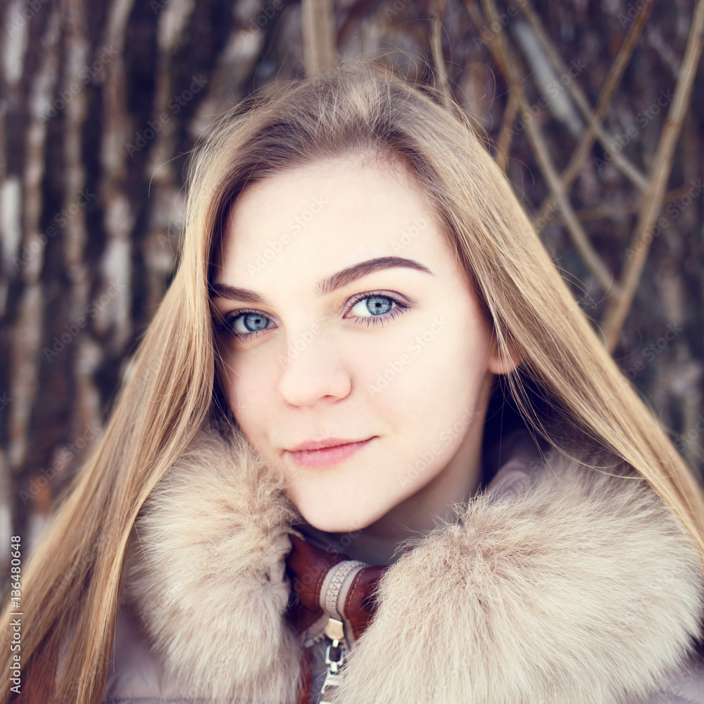 Portrait of Young smiling girl with long hair in winter park Portrait of Young smiling girl with long hair in winter park