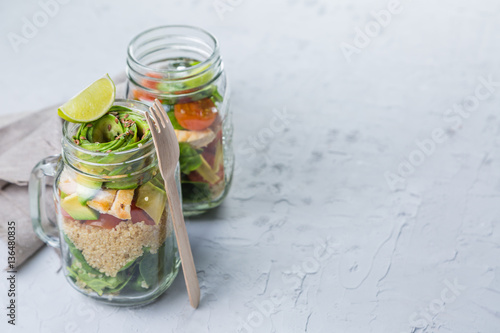 Fresh healthy salad in glass jar and ingredients