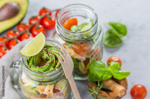 Fresh healthy salad in glass jar and ingredients