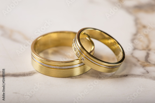 Two golden wedding rings on table