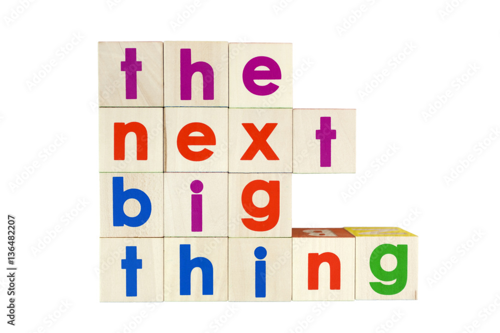 THE NEXT BIG THING concept spelled with colorful toy blocks. Isolated.