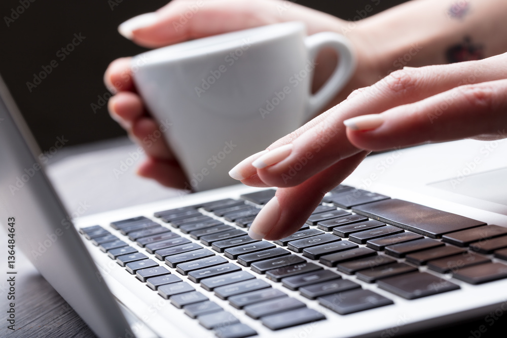 Close up view of the hand of a female typist Close up view of the hand of a female typist