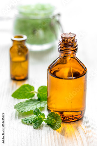 organic cosmetics with herbal extracts of mint on wooden background