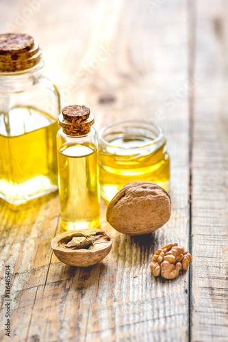 cosmetic and therapeutic walnut oil on wooden background