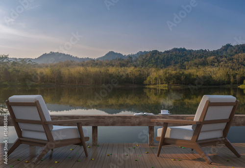 Lake house terrace and beautiful nature view 3d rendering image,A place surrounded by nature ,There are wood floor and furniture